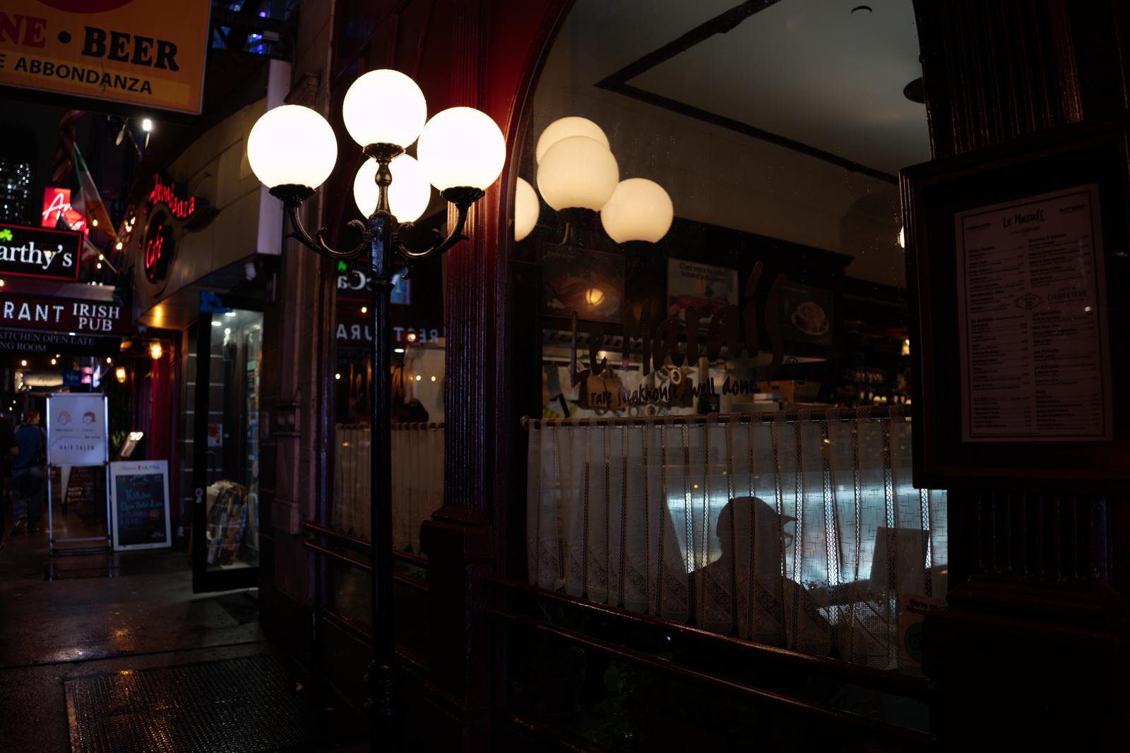 Pick: a pub front at night, globe lamps lit over the door